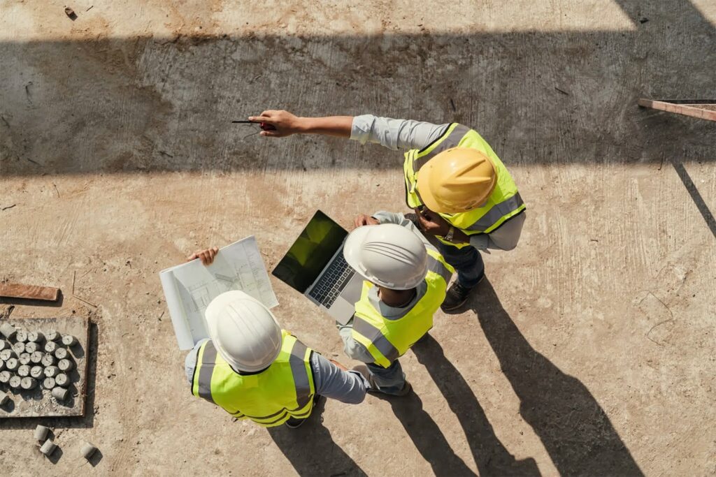 General contractor reviewing construction plans on site
